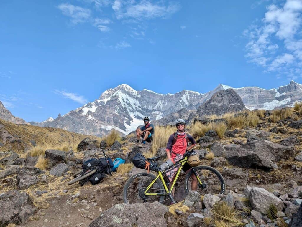 Two bikepackers stopped for a break on a technical climb on the Ausangate Circuit in Peru