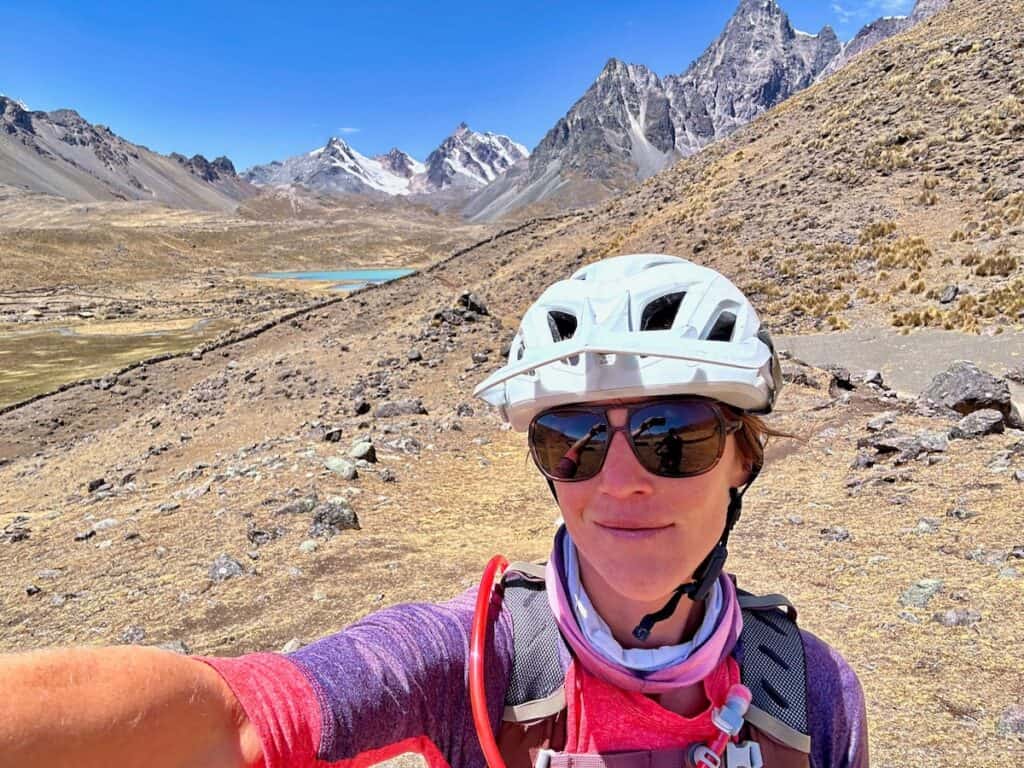 Woman cyclist taking a selfie in the backcountry of the Andes in Peru