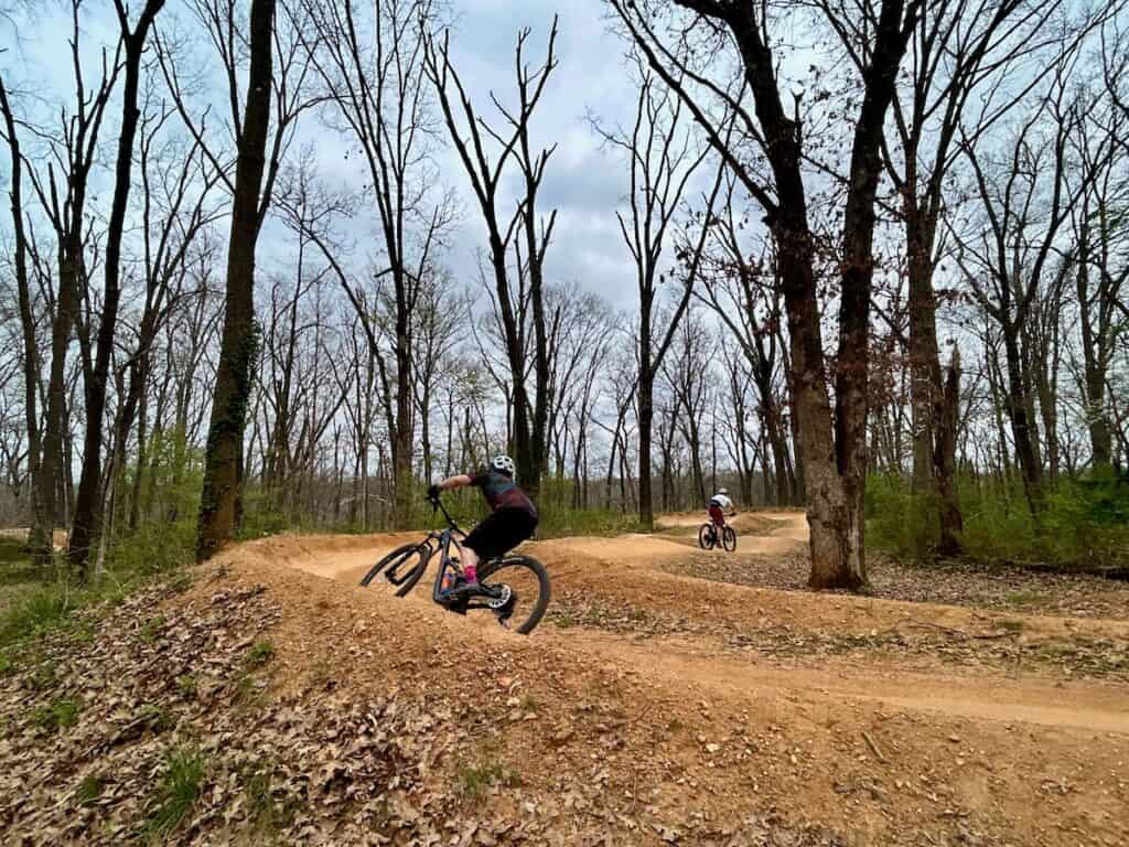 Mountain bikers on machine-built dual-slalom course